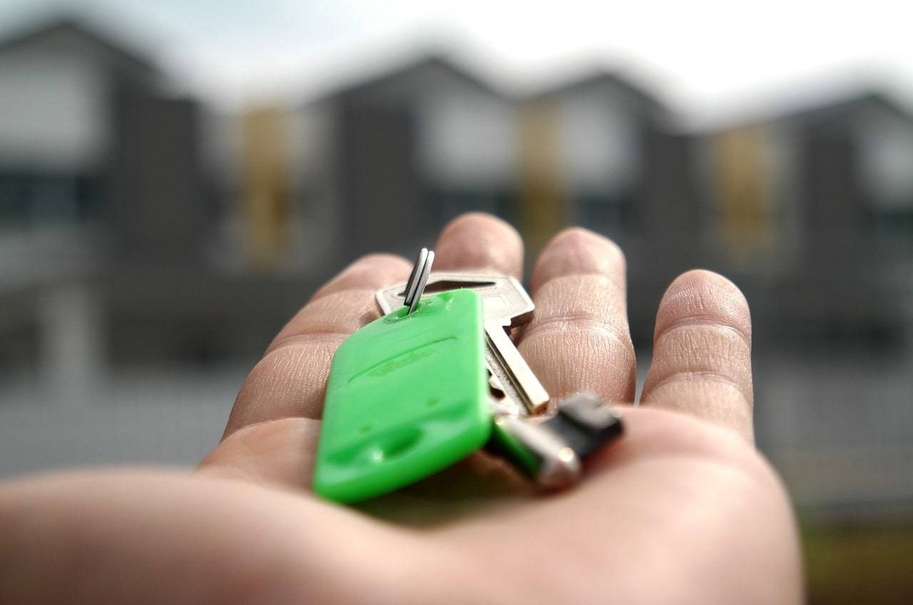 Handing over keys symbolizing owner peace of mind, Oak manages all necessary arrangements, including connecting you with professionals for rental management